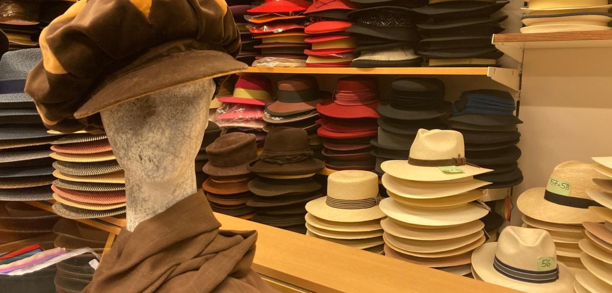 Modisten-Meisterin Anna Öckher vor Regalen voll mit bunten Hüten in ihrem St. Pöltner Geschäft. Foto: Althea Müller