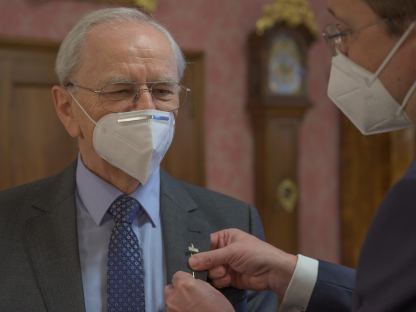 Bürgermeister Stadler steckt die Radhausnadel an Herrn Rottenschlagers Jackett.