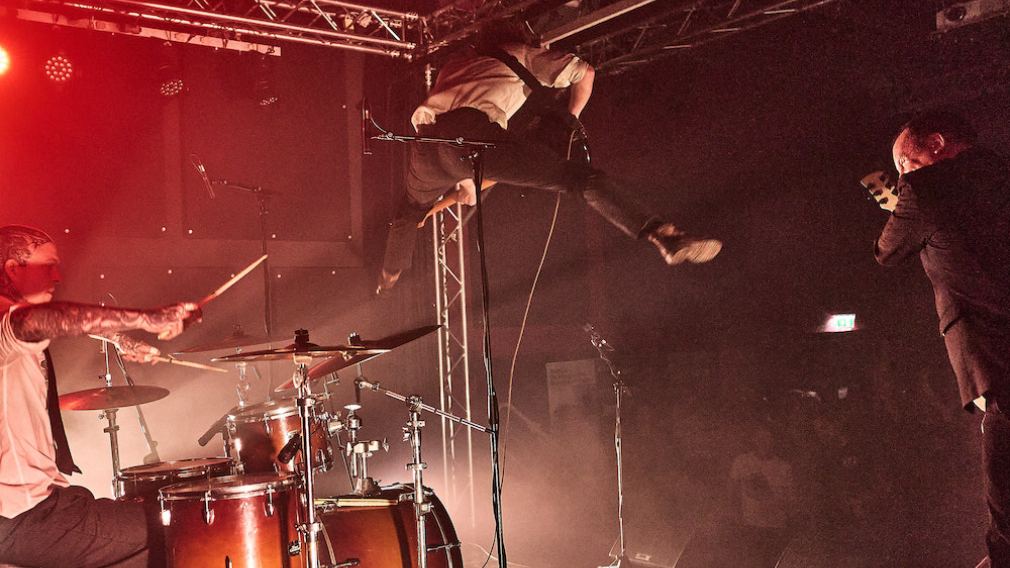 10 Mitarbeiter:innen vom Team vom Freiraum St. Pölten auf der Bühne vor rotem Vorhang. Foto: Klaus Engelmayer